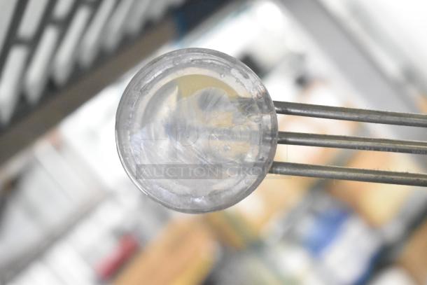 Clear round component with metal prongs, part of a mixed auction lot featuring Flavor Burst parts, Turbochef kickplate, and ballasts.