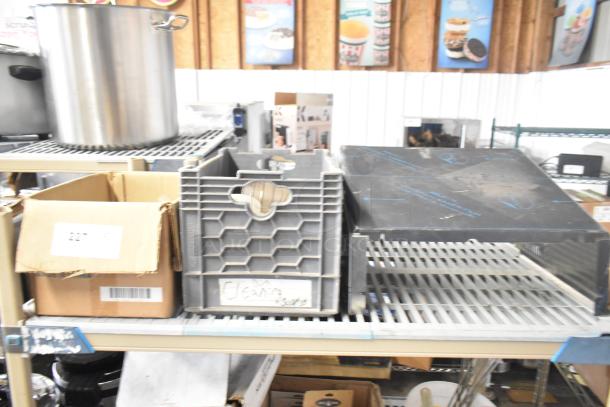 Tier lot of various items, including a large stainless steel pot, gray storage crate, and cardboard box. Items appear used.
