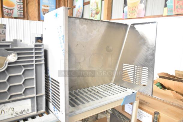 Tiered lot of various items including a stainless mixing cup collar and fluorescent sockets, in used condition.
