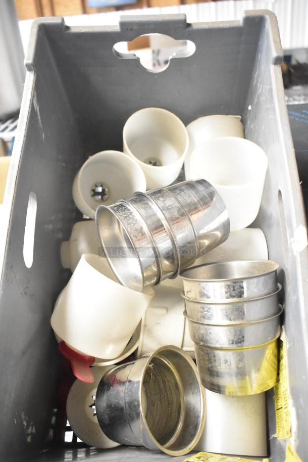 Tier lot of miscellaneous items including mixing cup collar and fluorescent sockets in a gray plastic bin.