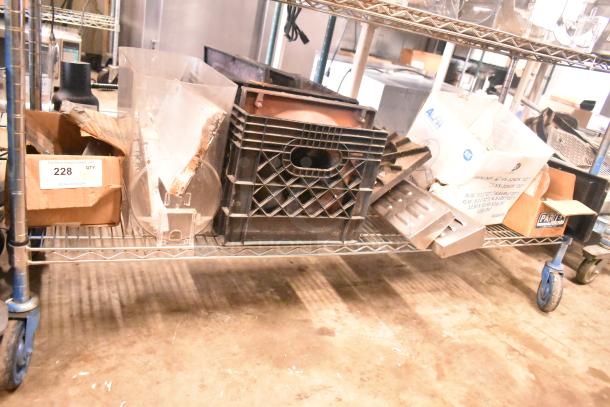 Tier lot including range grates, slushie machine hopper, and Turbochef kickplates on a metal shelf. Box tag: "228 QTY."