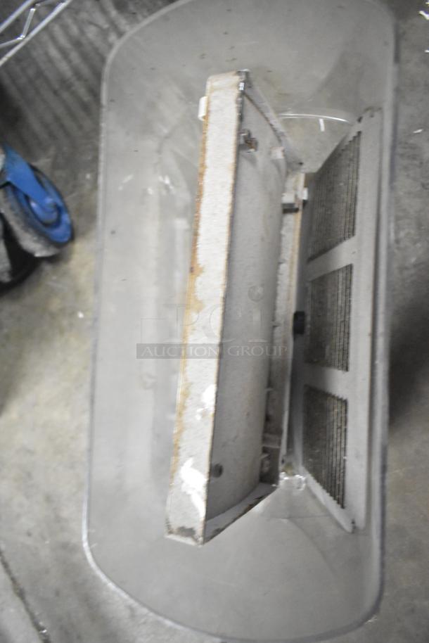 Auction lot image featuring a metal slushie machine hopper with visible wear. Part of a mixed item set including range grates and Turbochef kickplates.