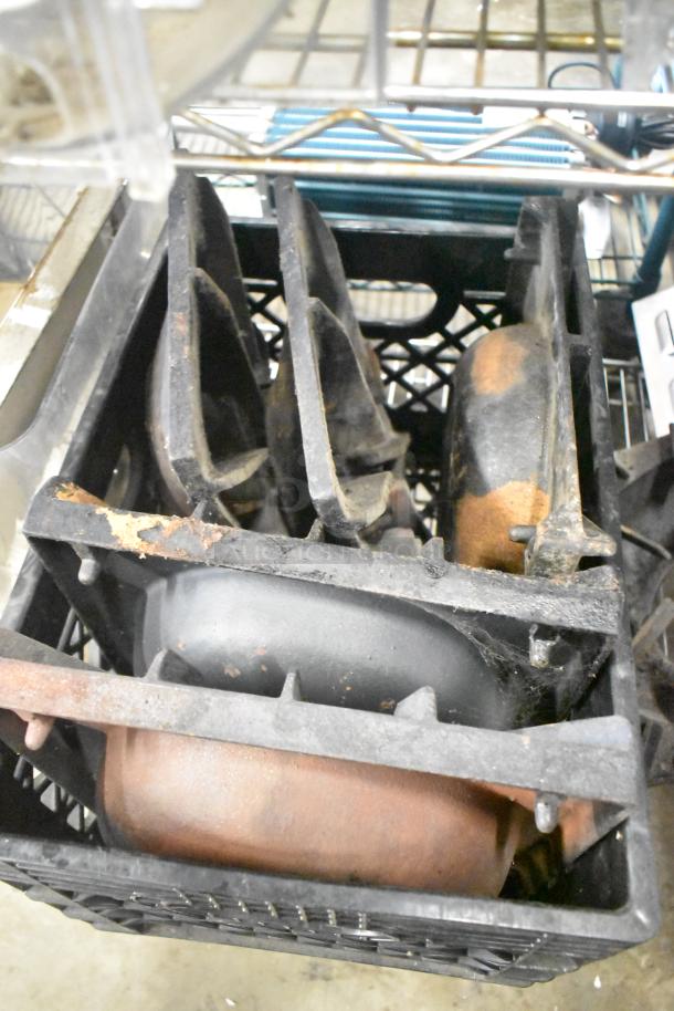 Crate of range grates in worn condition, part of a mixed item auction lot. Rust and wear are visible.