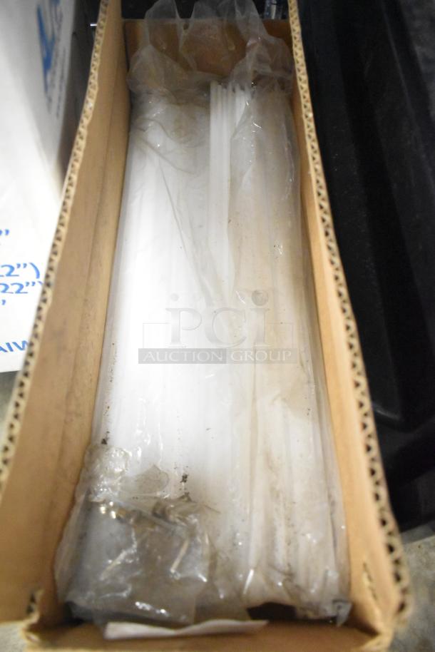 Box containing miscellaneous items like range grates, slushie machine hopper, and Turbochef kickplates. Items appear in mixed condition.