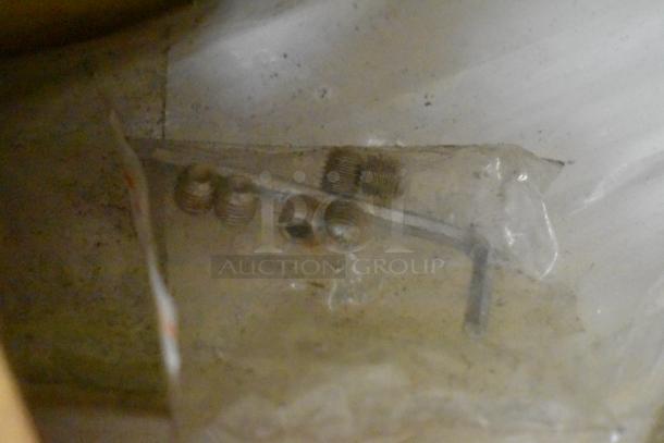 Mixed lot items including range grates, slushie machine hopper, and Turbochef kickplates in unclear condition.