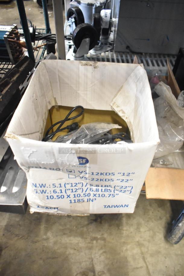 Box of various items including range grates, a slushie machine hopper, and Turbochef kickplates. Box dimensions and weight info visible.