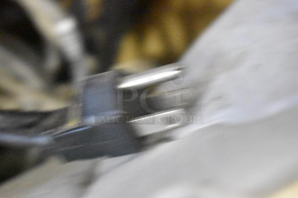 Blurry image of a plug emphasizing the diverse lot, including range grates, slushie machine hopper, and Turbochef kickplates.