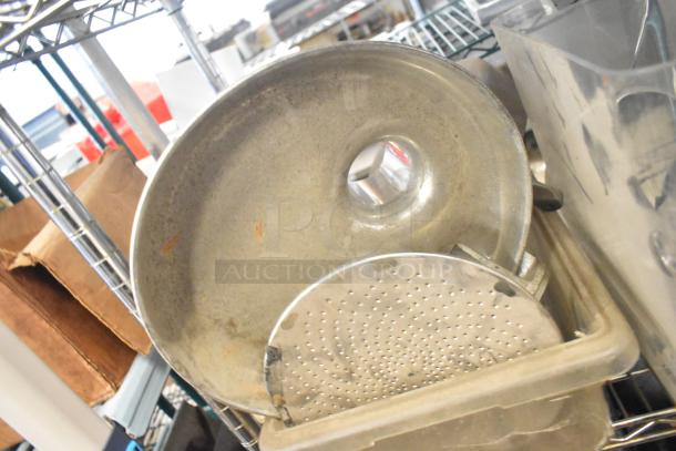 Alt text: Mixed lot including slushie machine hoppers, metal panels, meat grinder tray, and grating blade, on metal shelf.