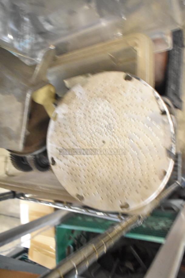 Auction lot featuring slushie machine hoppers, metal panels, meat grinder tray, and Pelican head grating blade. Used condition.