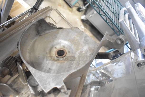 Auction lot with slushie machine hoppers, metal panels, meat grinder tray, and pelican head grating blade. Visible wear.