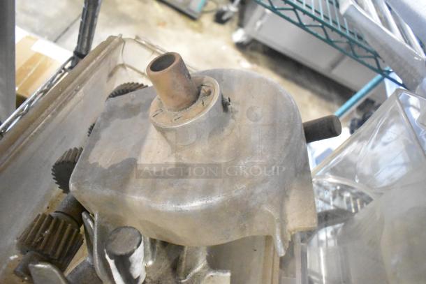 Auction item lot featuring slushie machine hoppers, metal panels, meat grinder tray, and pelican head grating blade.