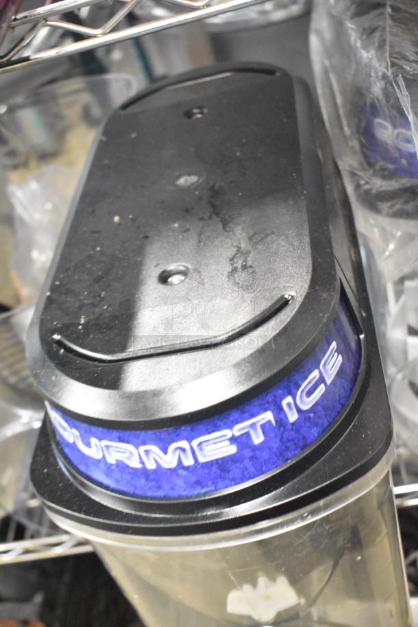 Auction lot featuring a "Gourmet Ice" branded slushie machine hopper with visible wear, part of a mixed item set.