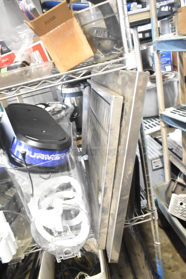 Auction item lot includes slushie machine hoppers, metal panels, meat grinder tray, and Pelican head grating blade.