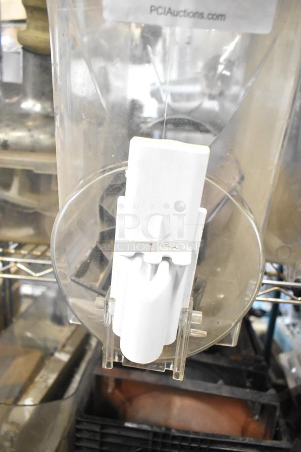 Auction lot includes slushie machine hoppers, metal panels, meat grinder tray. Visible label reads "PCIAuctions.com."