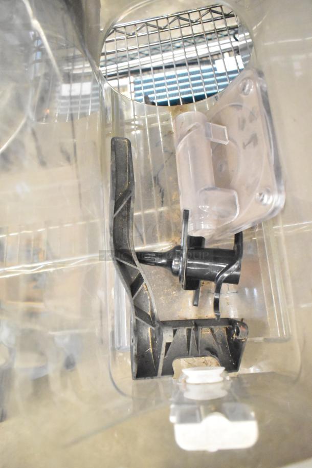 Tier Lot with clear plastic slushie machine hopper, black meat grinder tray, and metal grating blade. Visible wear.