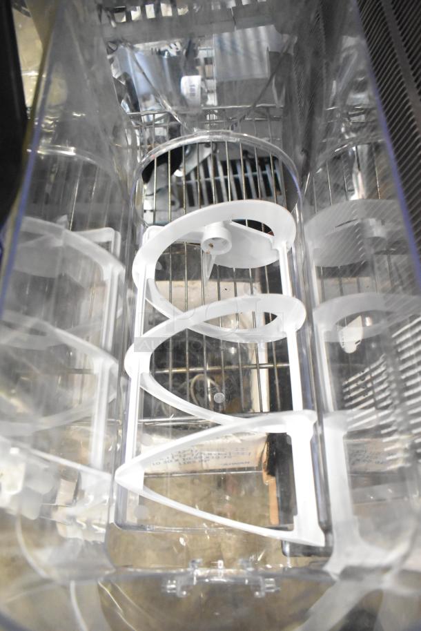 Tiered lot featuring slushie machine hoppers, shown with white plastic augers inside clear containers.