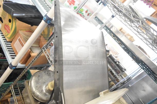 Assorted items including ice cream machine lids, ice head panel, switch kit for H-600, portafilters, and more on metal shelves.