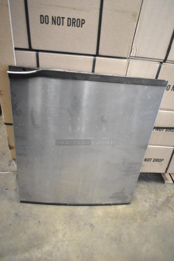 Steel panel from Ice Head machine, leaning on cardboard boxes labeled "DO NOT DROP." Panel shows minor wear.