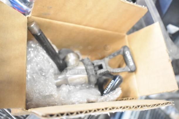 Auction item lot with ice cream machine lids, ice head panel, switch kit H-600, portafilters, Danfoss filter drier, and Bunn spouts in a box.