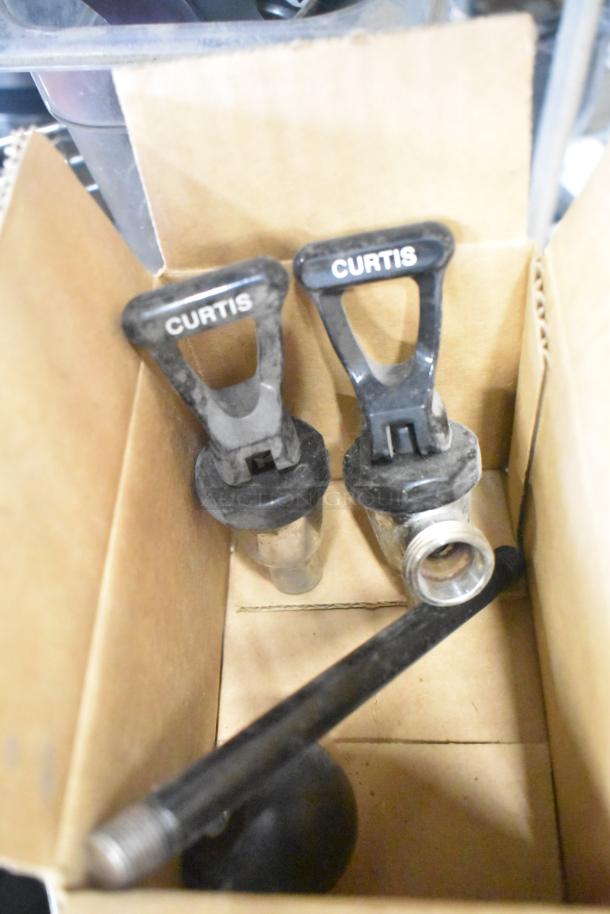 Cardboard box with Curtis dispenser spouts, part of a tier lot including ice cream machine lids, filter drier, ballast.