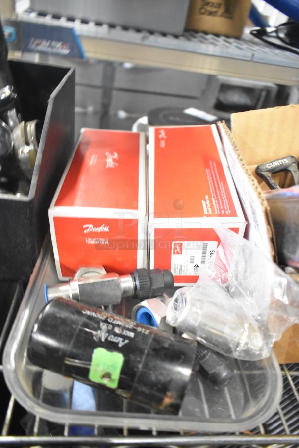 Tier lot including Danfoss filter drier, ice machine lids, portafilters, Bunn spouts, switch kit, in mixed condition.