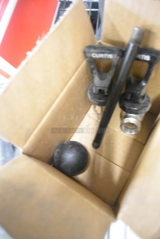Box with Curtis dispenser spouts and parts, potentially from a tier lot of various kitchen items.