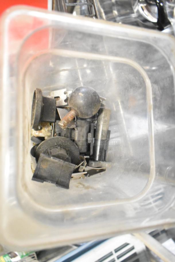 Tier lot of mixed items including ice cream machine lids, ice head panel, H-600 switch kit, portafilters, Danfoss filter drier, Bunn dispenser spouts.