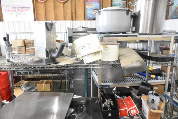 Auction lot featuring Pelican Head Blade, food processor grating/slicing blades, and meat slicer carriage. Item 231 tagged.