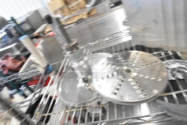 Assorted kitchen equipment lot including Pelican head blade, food processor grating/slicing blades, meat slicer carriage.