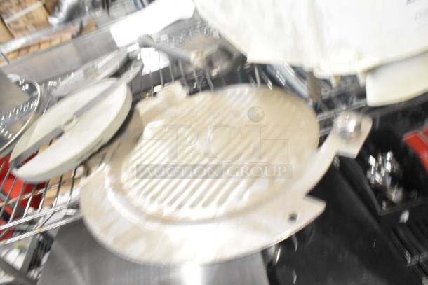 Tier lot with Pelican head blade, food processor grating/slicing blades, and meat slicer carriage. Mixed condition.