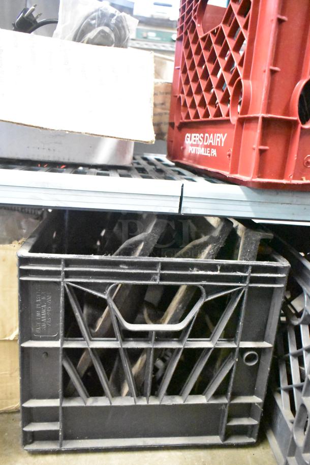 Nine metal grates for range stored in a black crate. Good condition, ideal for replacement or upgrades.