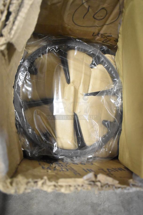 Nine metal range grates in original packaging, indicating good condition. Brown box with markings visible.