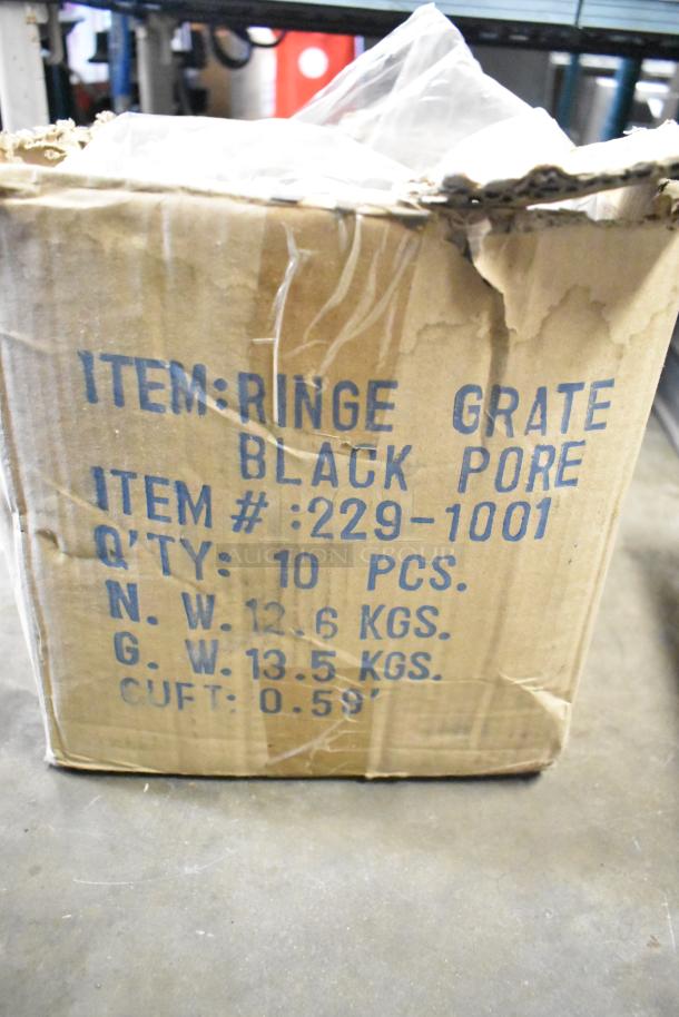 Worn cardboard box labeled for metal range grates, item #229-1001, 10 pieces, net weight 12.6 kg.