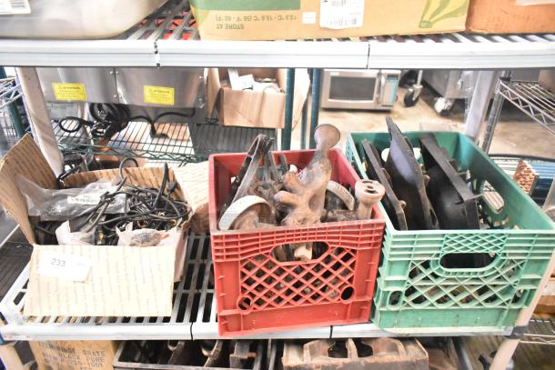 ALT text: Mixed lot in crates, including range burners, grates, and wires. Various conditions, ideal for parts or projects.