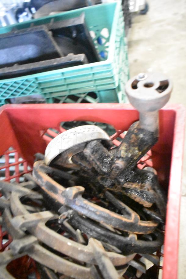 Tier lot of stove parts including range burners, grates, and wires in crates. Items show signs of wear.