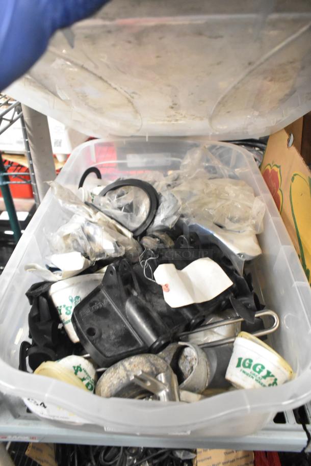 Container filled with assorted Taylor ice cream machine parts, beverage machine adapters, and miscellaneous items, in used condition.