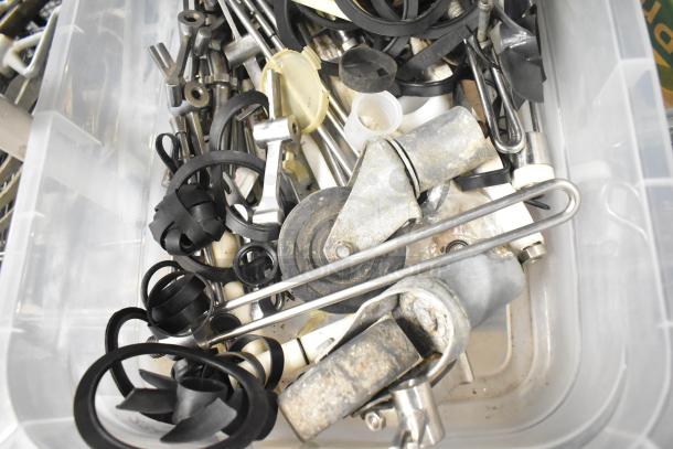 Tier lot of assorted machine parts in a plastic bin, including Taylor ice cream machine parts and carbonated beverage adapters.