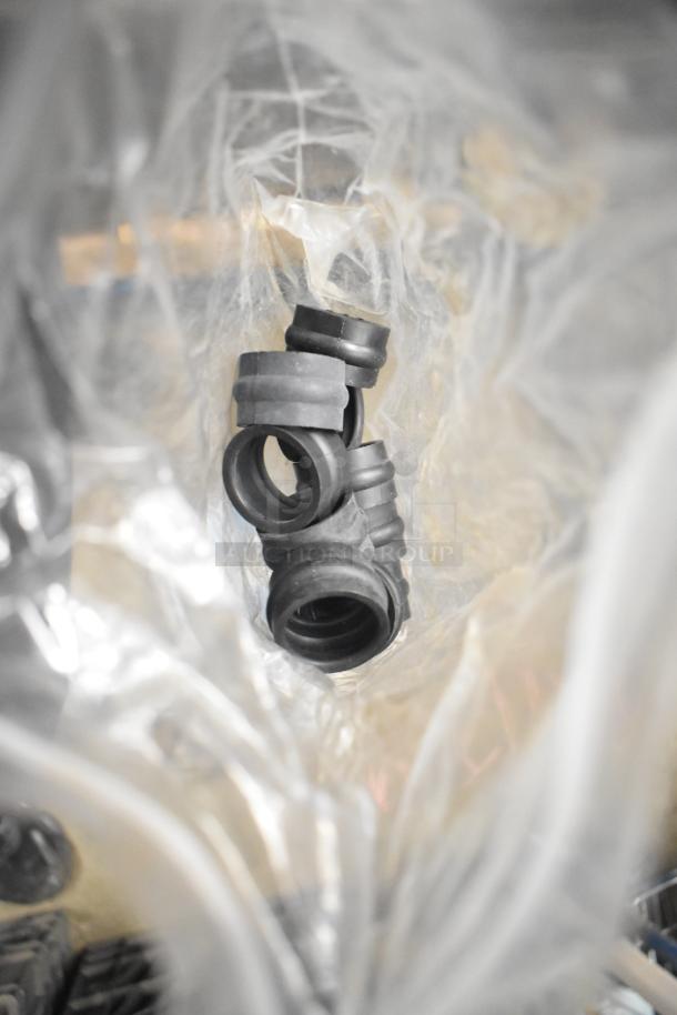 Tier lot of various machine parts, including black rubber adapters and components for Taylor ice cream and carbonated beverage machines.