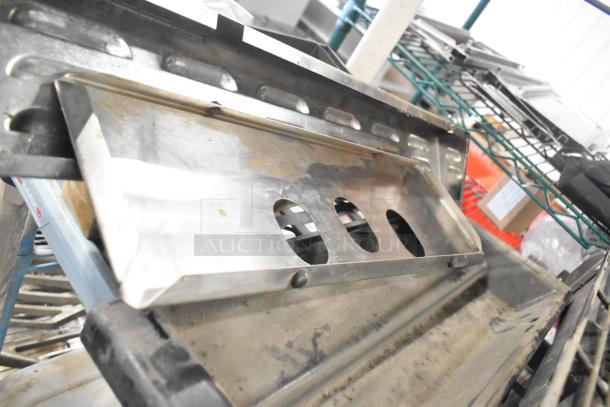 Tier lot featuring a Turbochef kickplate and various drip trays, showing wear, suitable for parts or replacements.