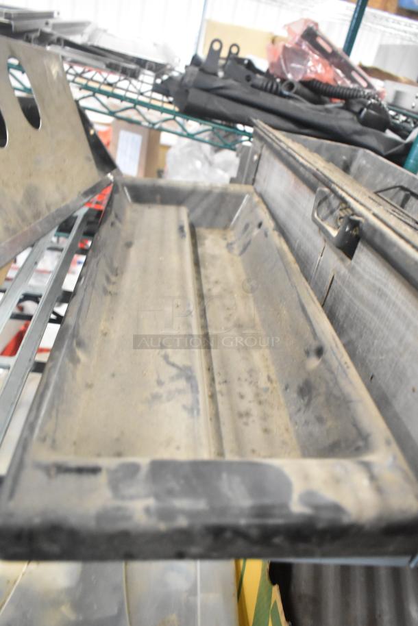 Tier lot featuring a Turbochef kickplate, Taylor ice cream machine drip tray, and carbonated beverage machine drip tray. Dusty condition.