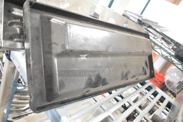 Assorted lot featuring a black Turbochef kickplate and Taylor ice cream machine drip tray, both showing signs of use.