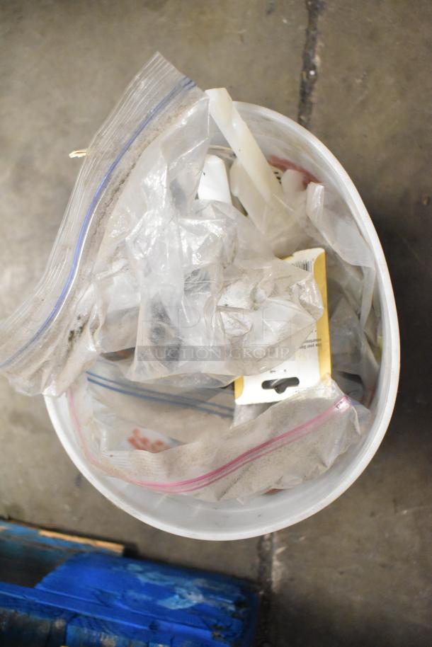 Bucket containing assorted items including Turbochef kickplate, Taylor ice cream machine drip tray, in varying conditions.