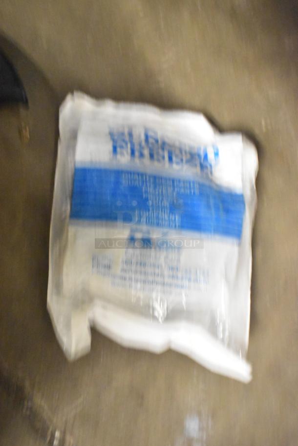 Blurry image of a packaged plastic component with blue labeling, part of a tier lot including appliance trays.