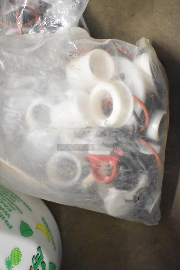 Plastic bag with various small parts, including washers and gaskets, part of a mixed auction lot. Item condition appears used.