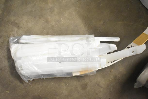 Tier lot of kitchen appliance accessories including a Turbochef kickplate and drip trays in plastic wrap.