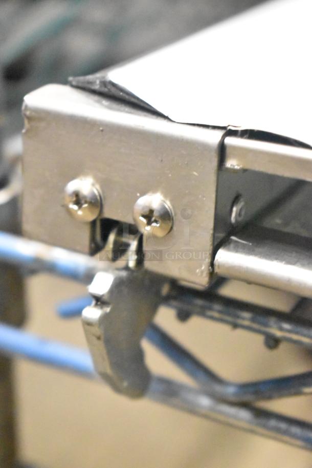 Metal hinge detail of a convection oven replacement door, featuring two visible screws, indicating durability and precise fit.