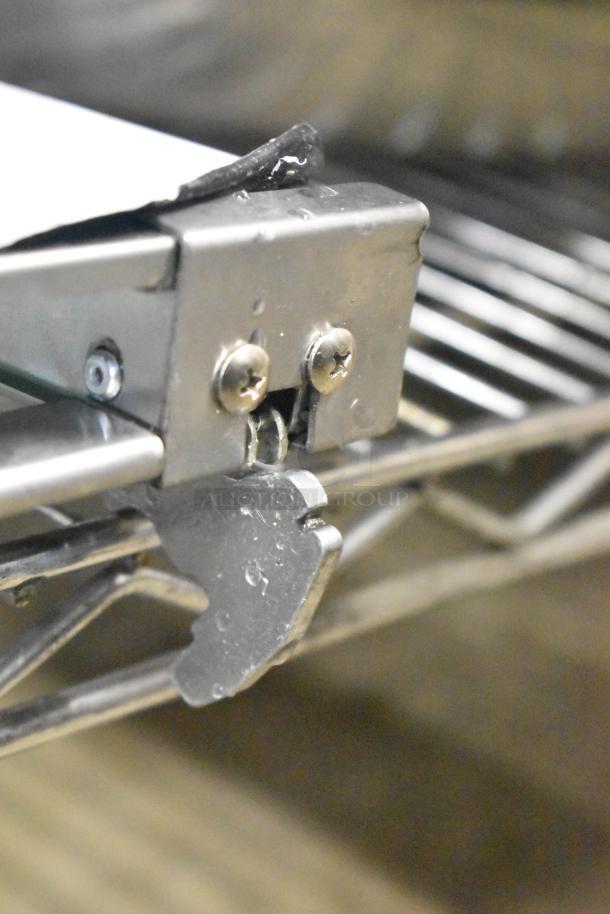 Convection oven replacement door hinge, metal construction, close-up view showing screws and latch, in good condition.