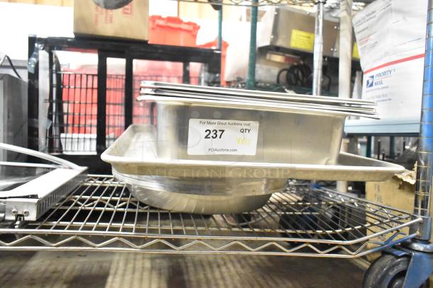 12 various items including metal baking pan, stainless steel drop-in bins. Sticker indicates PCI Auctions lot 237.