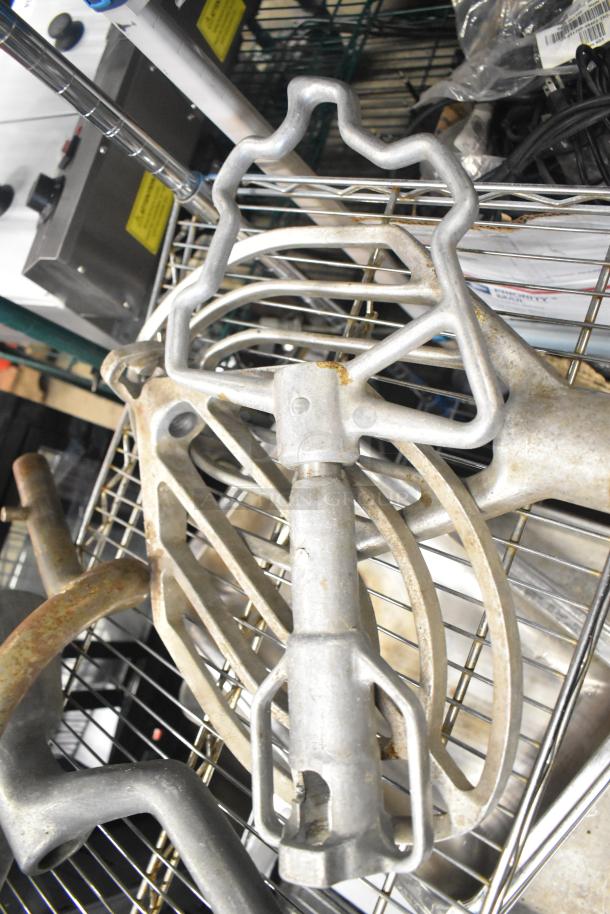 15 Hobart Mixer attachments including dough hooks, paddle whips, whisk. Used condition, metal construction. 15 times your bid.