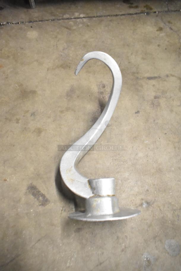 Dough hook attachment for Hobart mixer in used condition, metal construction, ideal for kneading dough.